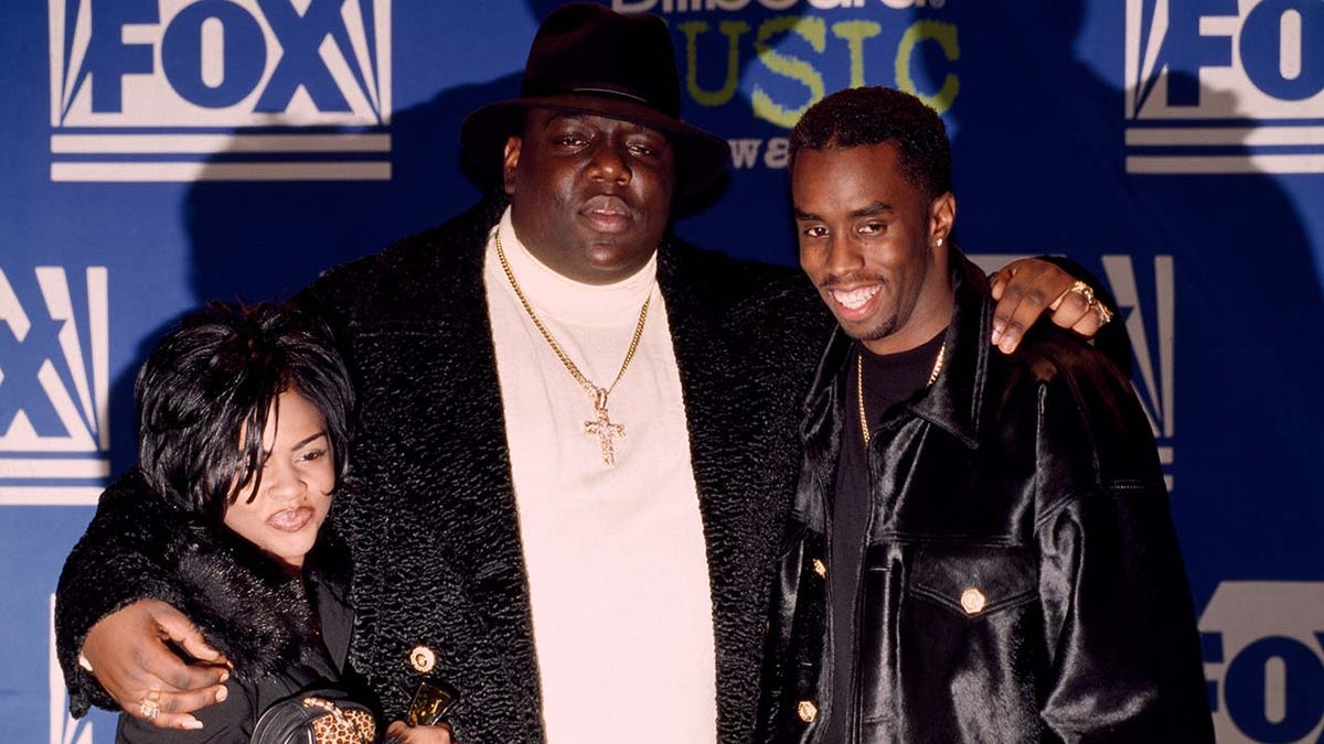 Music mogul Sean Combs wears all black on red carpet with Notorious B.I.G. and Lil Kim.