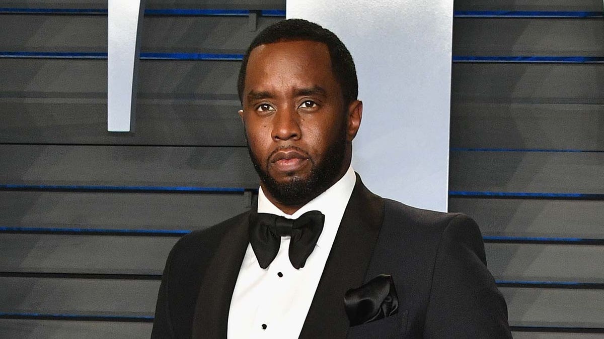Rapper Sean Combs wears black suit with bow tie at Oscars party