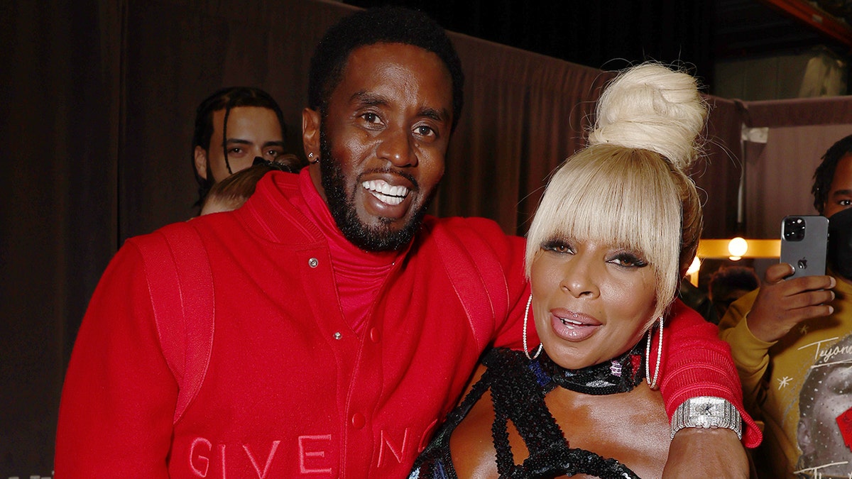 Sean "Diddy" Combs and Mary J. Blige smiling together.