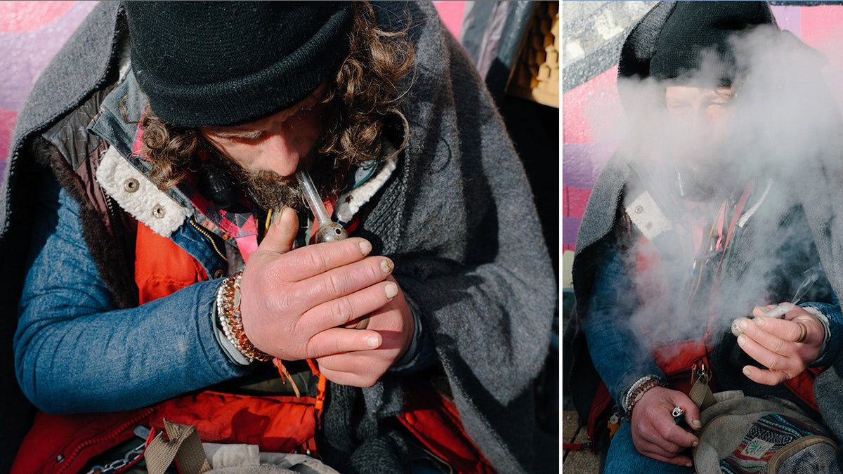 A man holds a lighter under a meth pipe in Portland