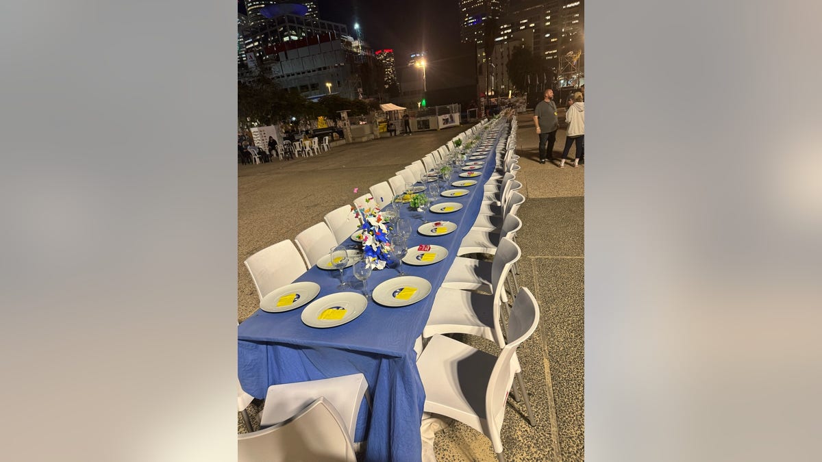 A long symbolic Shabbat dinner table sits empty in Israel, awaiting the hostages to take their places.
