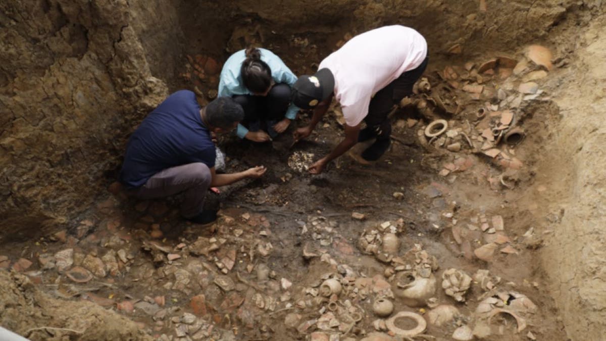 Archaeologists digging in tomb