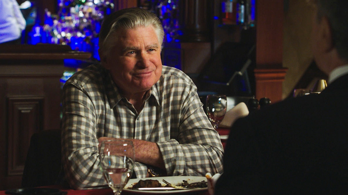 Treat Williams crosses his arms wearing a plaid shirt on Blue Bloods