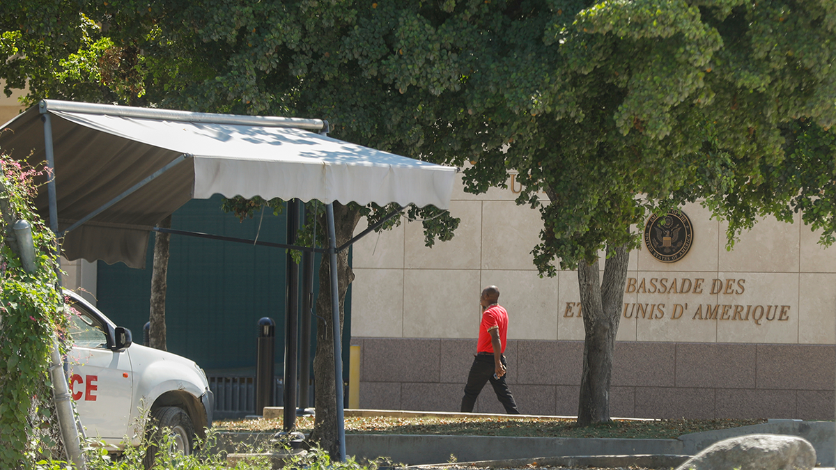 A man enters the U.S. embassy in Port-au-Prince, Haiti.