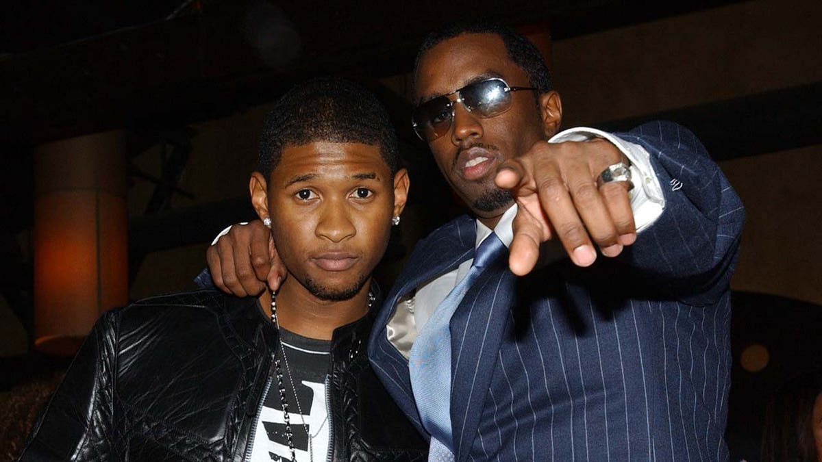 Sean Combs wears pinstripe suit with singer Usher.