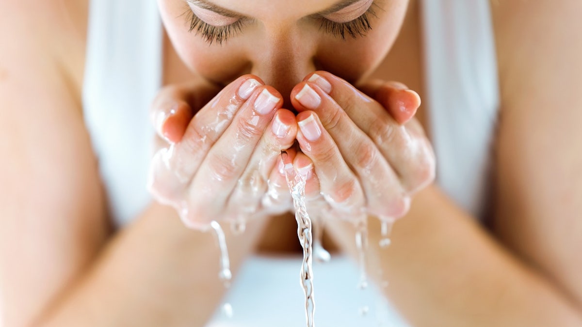 Woman washing face