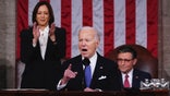 President Joe Biden delivers the State of the Union address to a joint session of Congress at the Capitol, Thursday, March 7, 2024, in Washington. Standing at left is Vice President Kamala Harris and seated at right is House Speaker Mike Johnson, R-La. (Shawn Thew/Pool via AP)