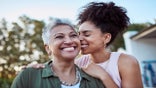 Smile, mother and child in a garden for love, peace and care together on mothers day. Happy, relax and calm woman with  affection for her senior mom at a home for people in retirement in a backyard