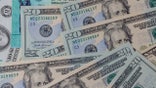 COVID-19 on global pandemic lockdown, stimulus package financial package government for people, US dollar cash banknote on American flag