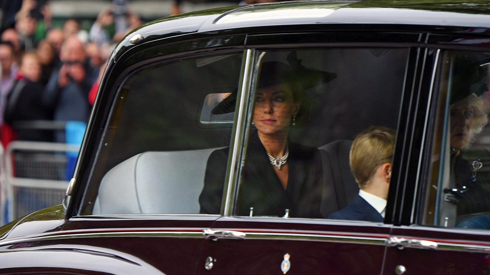 Princess Catherine looks out of the window of a limousine