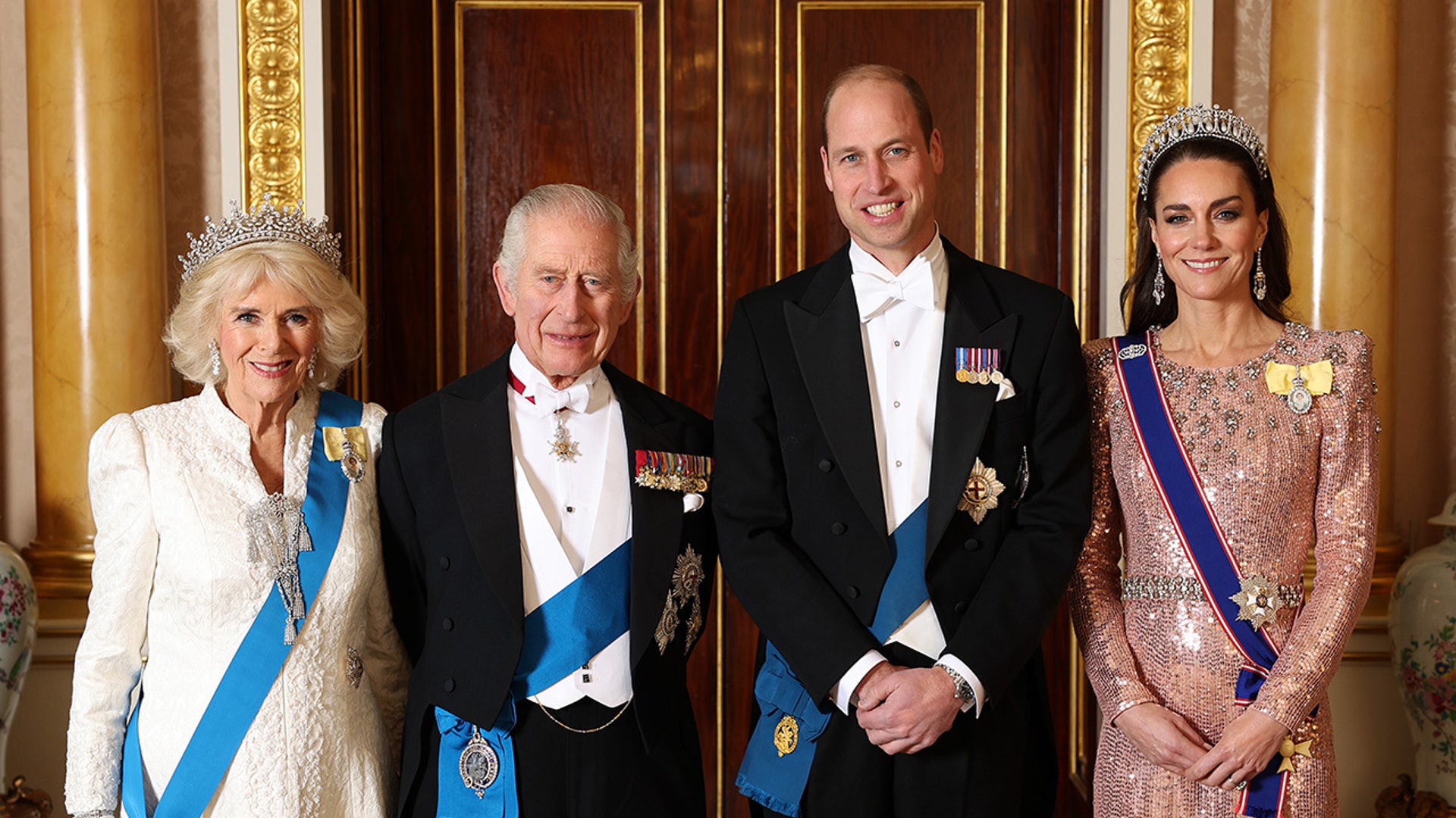 Queen Camilla, King Charles III, Prince William, Prince of Wales and Catherine, Princess of Wales in formal clothes and medals