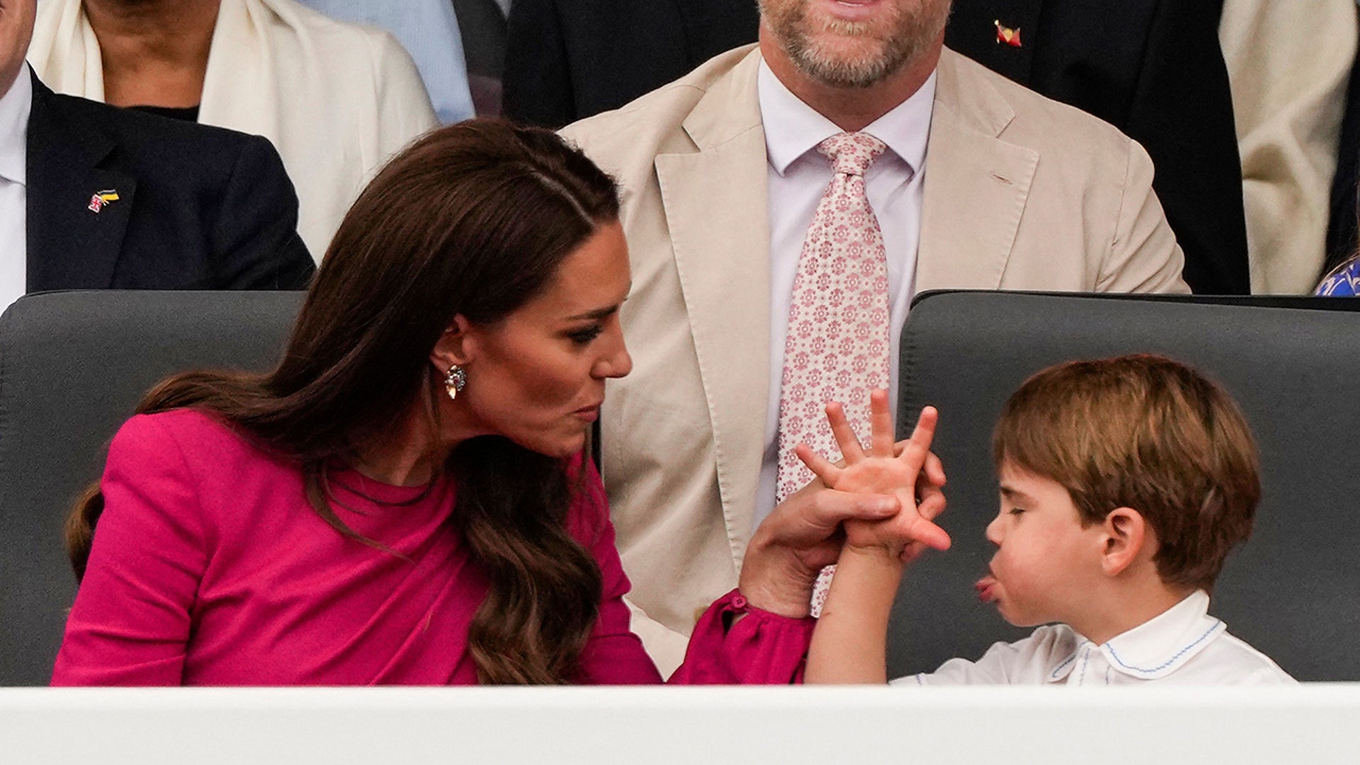 Princess Catherine corrects Prince Louis as he gestures at her in the stands