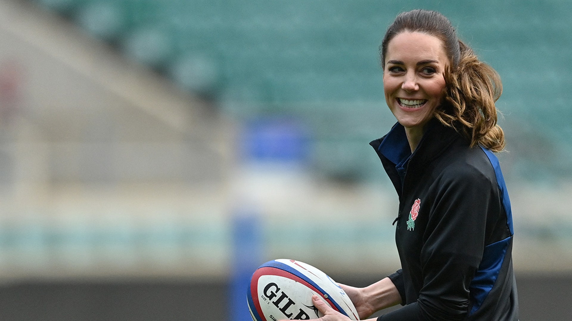 Princess Catherine passes a football