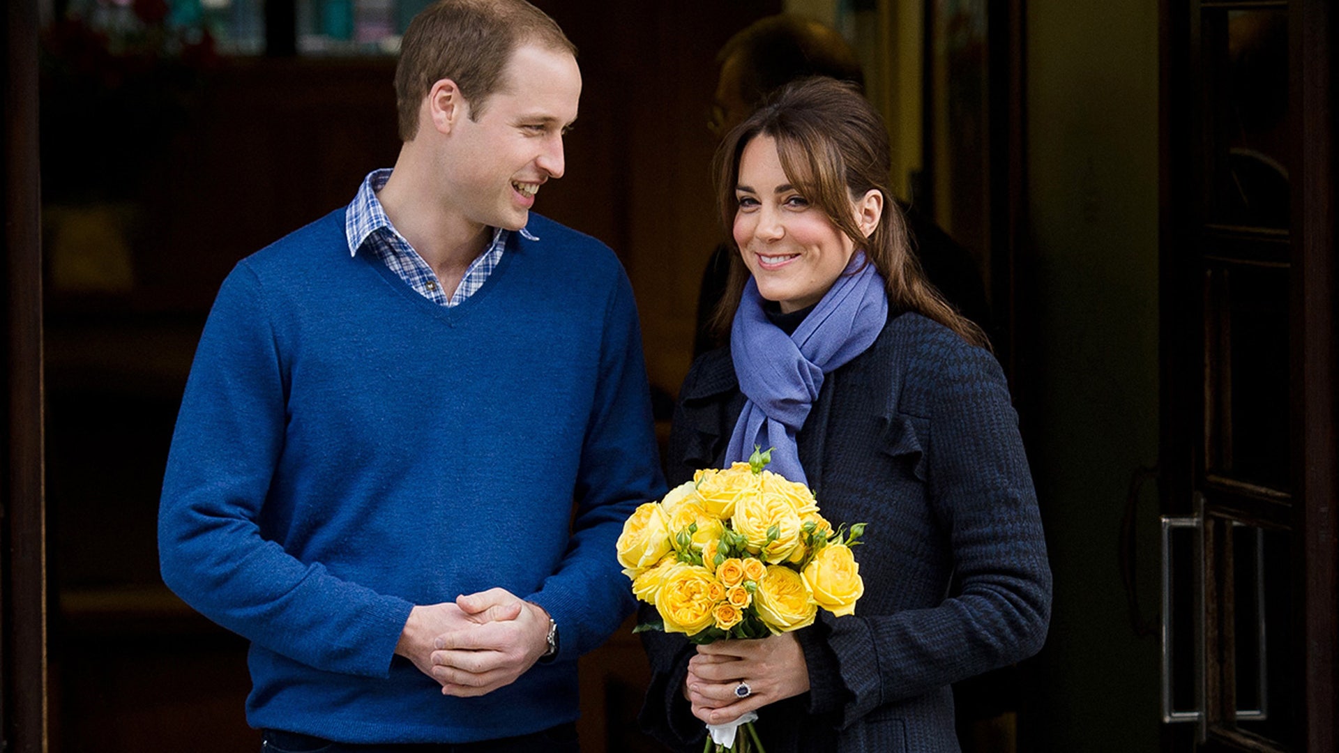 Princess Catherine holds flowers, both her and Prince William are dressed in blue.