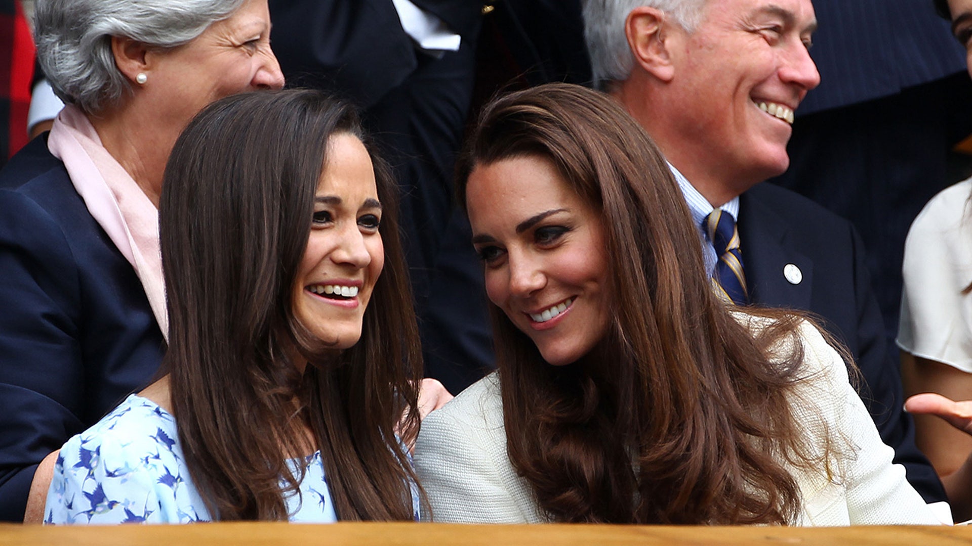 Pippa and Kate Middleton laugh in the stands at a tennis match