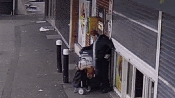 Elderly woman caught on store shutter accidentally gets lifted off the ground