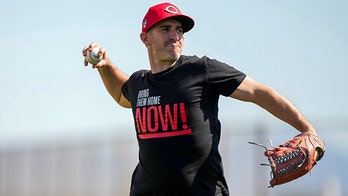 Reds coach Alon Leichman shows off 'Bring Them Home Now!' glove in support of Israel