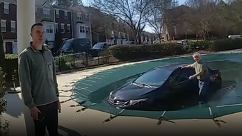 Bizarre video shows Georgia police rescuing driver who crashed on top of covered pool