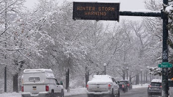 Snow piles onto Denver by the foot; airport, major highway shut down