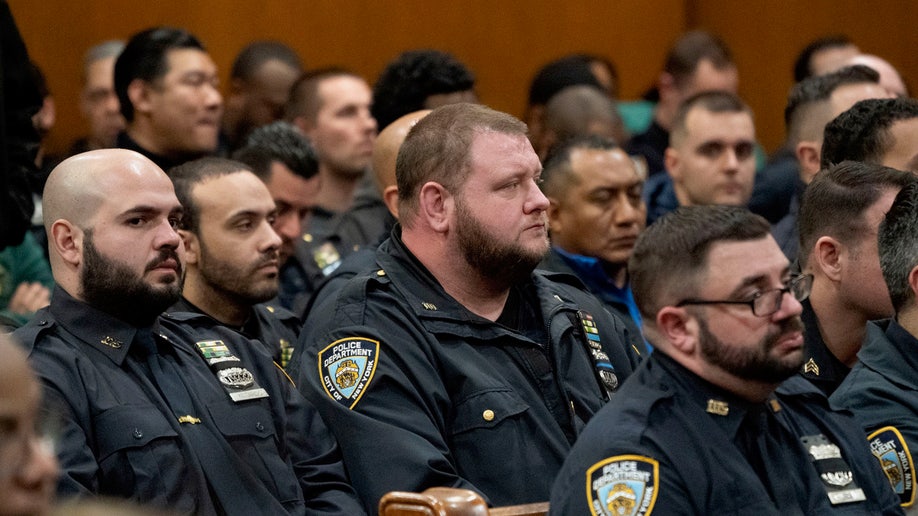 NYPD officers watch the court proceeding