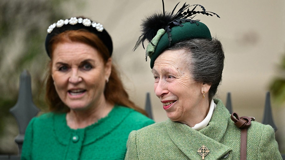 Sarah Ferguson in an bright green jacket and black bejeweled headband walks behind Anne, Princess Royal to attend church service