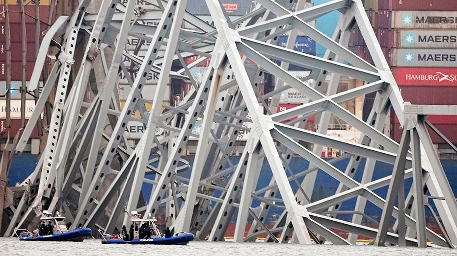 Baltimore bridge collapse: Vehicle removed from water, another hanging from metal