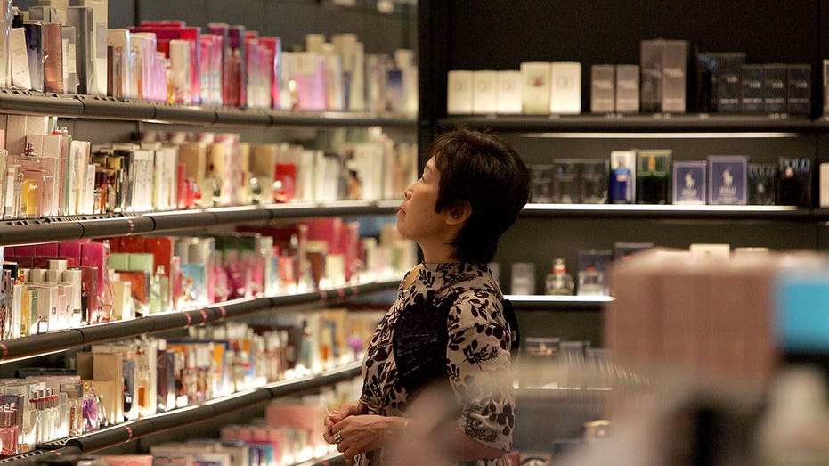Woman browses through perfume at a Sephora