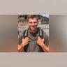 Garrison Brown from Sister Wives wears a backpack and brown shirt