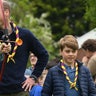 Princess Catherine shoots an arrow as Prince William laughs