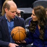Prince William looks perplexed as handed a basketball by Princess Catherine