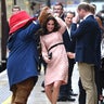 Princess Catherine dances with Paddington Bear as Prince William stands there