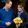 Princess Catherine holds flowers, both her and Prince William are dressed in blue.
