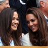 Pippa and Kate Middleton laugh in the stands at a tennis match
