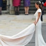 Pippa Middelton holds the train of Kate Middleton's wedding dress