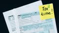 A tax time Post-it on tax documents