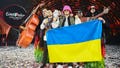 Members of the band "Kalush Orchestra" pose onstage with the winner's trophy and Ukraine's flags after winning on behalf of Ukraine the Eurovision Song contest 2022 on May 14, 2022 at the Pala Alpitour venue in Turin.
