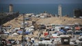 People walk in a camp for displaced people in Rafah in the southern Gaza Strip by the border with Egypt on April 28, 2024, amid the ongoing conflict between Israel and the Palestinian militant group Hamas.