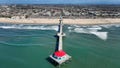 Waves roll past the Huntington Beach Pier, epicenter of the city's beach culture, in Huntington Beach, Ca. on February 22rd, 2024.