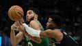 Milwaukee Bucks' Malik Beasley knocks the ball from Boston Celtics' Jayson Tatum during the first half of an NBA basketball game Tuesday, April 9, 2024, in Milwaukee.