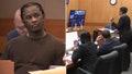 Rapper Young Thug sits in a Georgia courtroom as a prosecutor argues with a judge on Wednesday.
