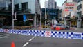 Police block a street near a crime scene at Bondi Junction in Sydney, Sunday, April 14, 2024, after several people were stabbed to death at a shopping center Saturday. Police have identified Joel Cauchi, 40, as the assailant that stabbed several people to death at a busy Sydney shopping center Saturday before he was fatally shot by a police officer. (AP Photo/Rick Rycroft)