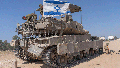 An Israeli soldier attaches an Israeli flag on top of an armoured personnel carriers (APC) near Israel's border with Gaza, in southern Israel, Monday, April 15, 2024. - Fox News
