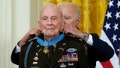 FILE - President Joe Biden presents the Medal of Honor to retired U.S. Army Col. Ralph Puckett, in the East Room of the White House, Friday, May 21, 2021, in Washington. Puckett, a retired Army colonel awarded the Medal of Honor seven decades after he was wounded leading a company of outnumbered Army Rangers in battle during the Korean War, died peacefully Monday, April 8, 2024, at his home in Columbus, Ga., according to the Striffler-Hamby Mortuary, which is handling funeral arrangements. He was 97. (AP Photo/Alex Brandon, File)