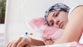 Photo of young pretty cancer girl lying in hospital