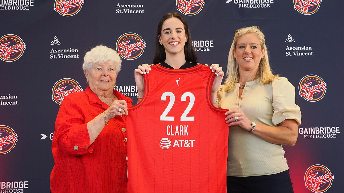 Caitlin Clark poses pinch jersey