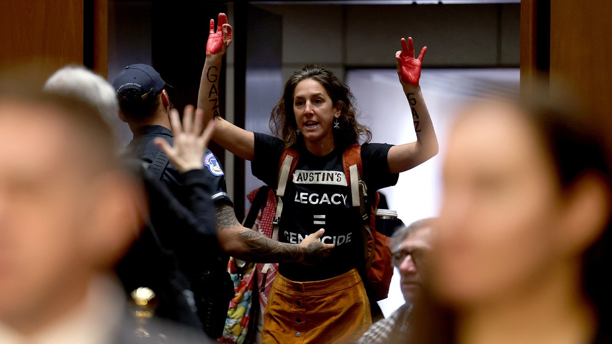 A Capitol Police Officer removes a protester