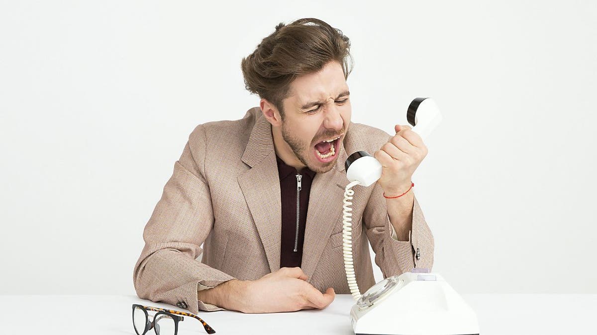 Man yelling into the phone (Kurt "CyberGuy" Knutsson)