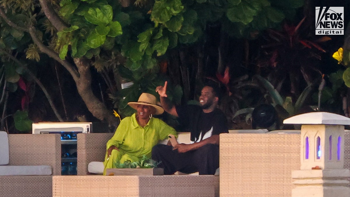Sean "Diddy" Combs sits outside of his Star Island home with his mother, Janice Combs, in Miami Beach, Florida