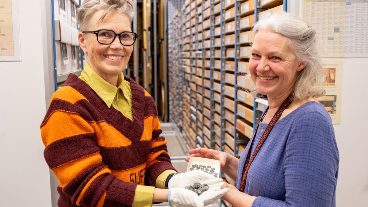 Smiling women holding coins