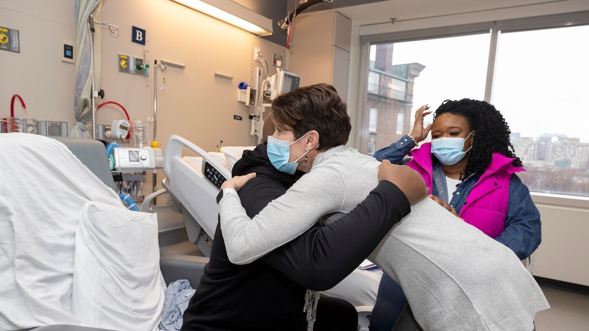 Slayman hugs his patient advocate, Susan Klein, before being discharged.